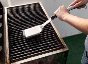 cleaning a grill with wirebrush